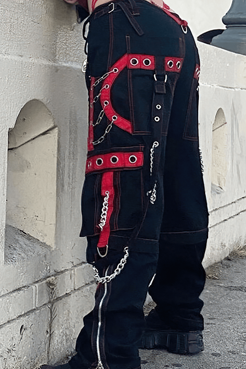 Trendy women's black wide-leg cargo pants with red accents and chains, perfect for a punk-inspired fashion statement.