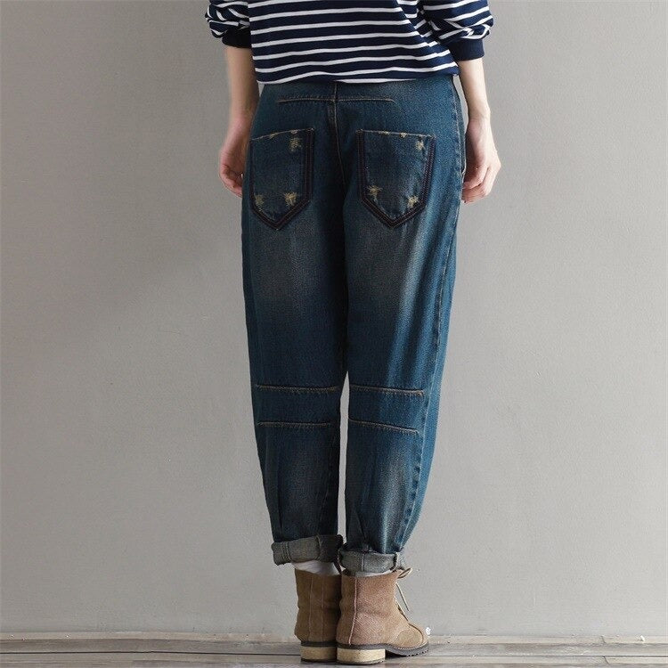 Women plus size boyfriend jeans featuring durable denim and a stylish cuffed hem, perfect for urban alternative fashion.