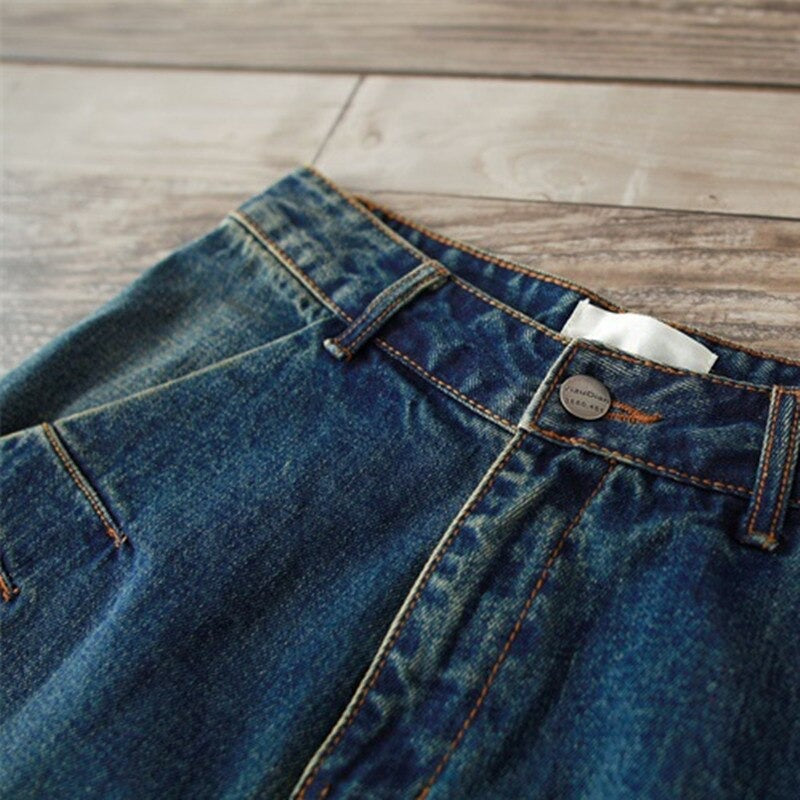 Close-up of women's plus size jeans waistband with button, showcasing durable denim and stylish urban flair.