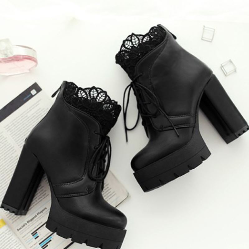 Women lacing gothic style platform boots in black with high heel and lace detail, perfect for fashionable outfits.