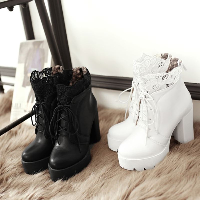 Women lacing platform boots in black and white, featuring high square heels and lace details, perfect for gothic outfits.