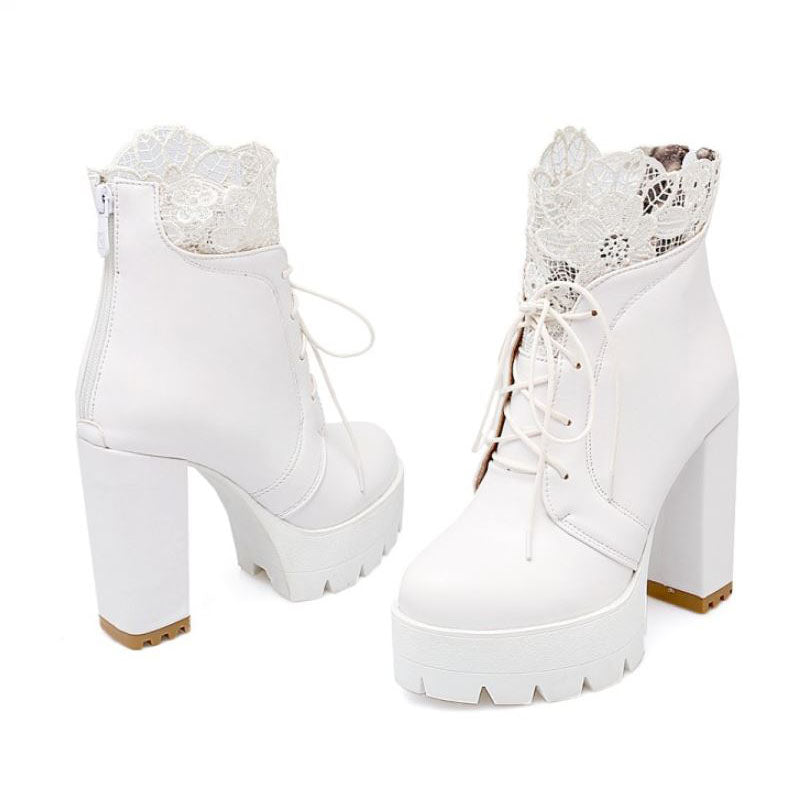 Women’s gothic style white platform ankle boots with lace detail and high heels.