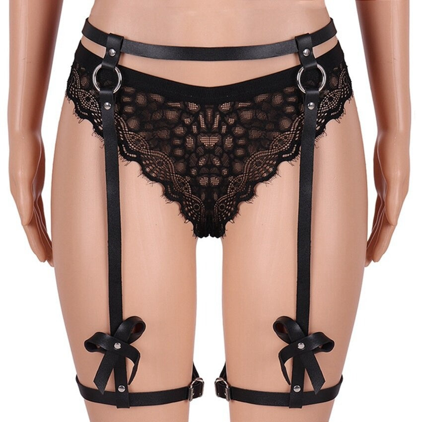 Women's black PU leather body harness with bows, gothic bondage garter belt for legs, perfect for Halloween and rave outfits.