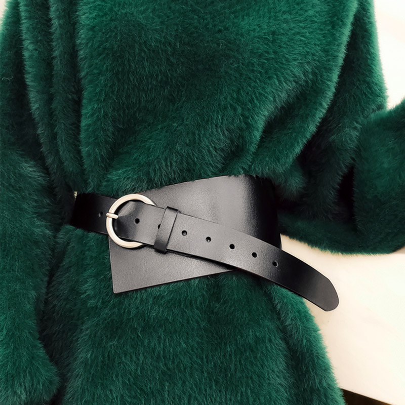 Women PU leather waist corset belt in black with silver buckle, styled with a cozy green outfit.