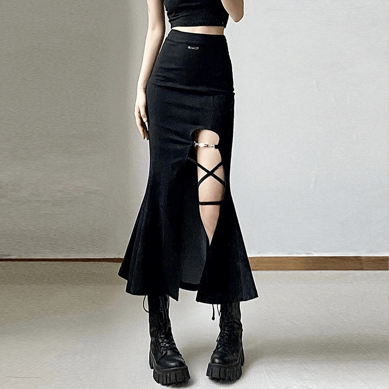 Women's black flared skirt with split, gothic style, featuring crisscross detail and paired with chic combat boots.