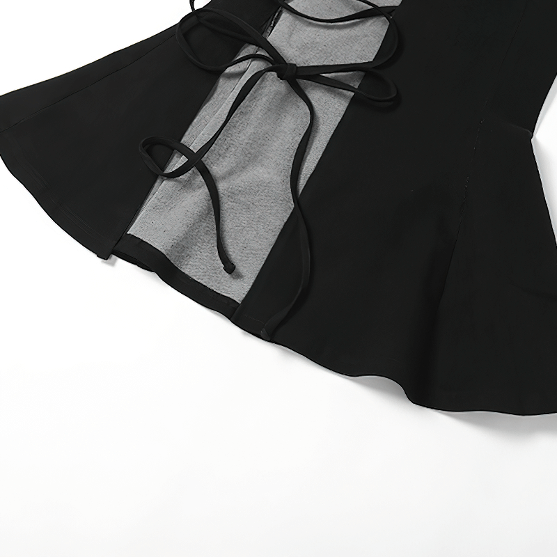 Close-up of a women's black flared skirt featuring a split design, gothic style with stylish tie details.