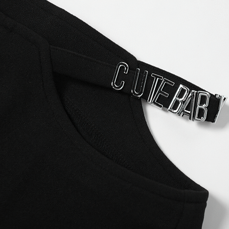 Close-up of a black garment featuring a strap with 'CUTE BABY' text, showcasing stylish design details.