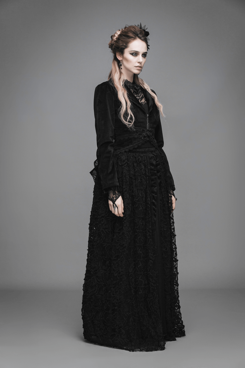 Gothic woman in elegant black lace dress with dramatic hairstyle, showcasing a dark, stylish aesthetic.