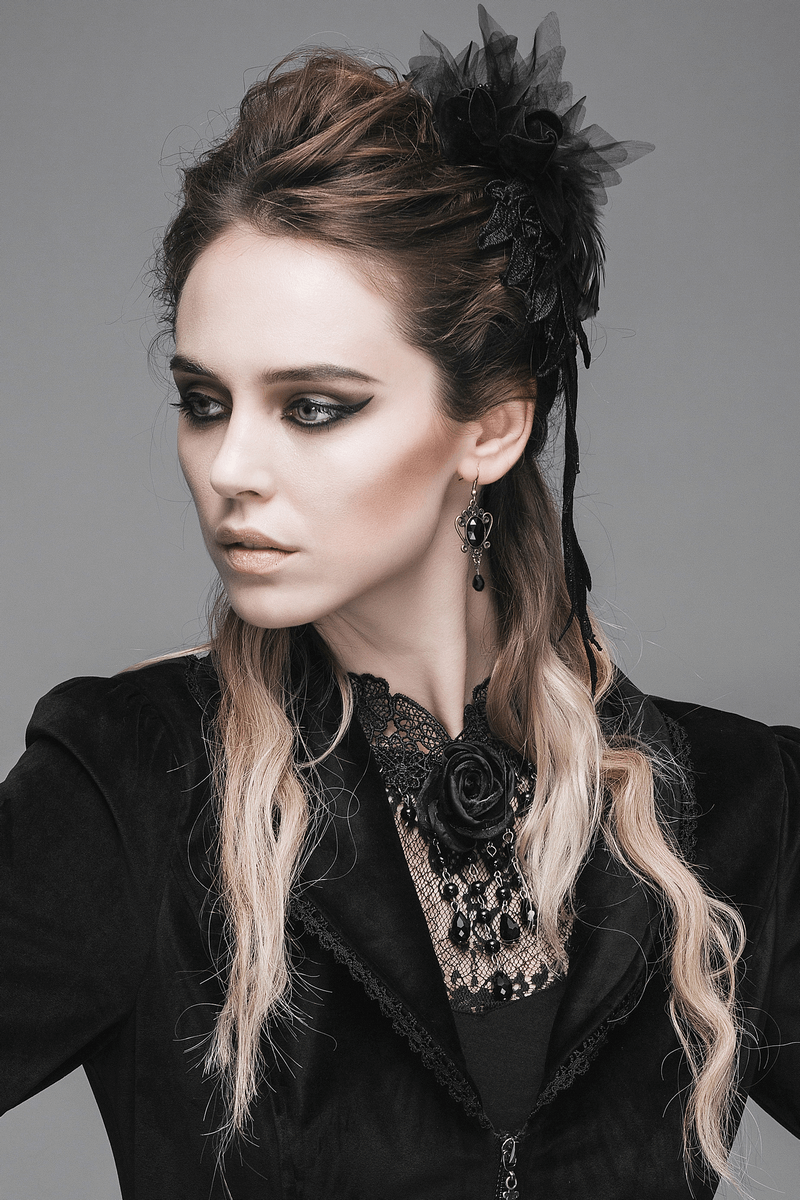 Elegant woman in gothic attire wearing a black lace necklace with a rose, showcasing a stylish and sophisticated look.