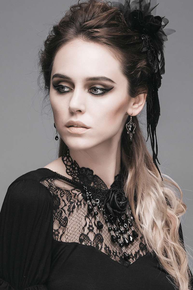 Elegant woman wearing a women's black lace necklace with rose, showcasing a gothic style look.