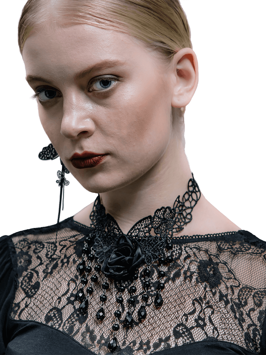 Elegant woman wearing a black lace necklace with rose, showcasing gothic style and luxury fashion.