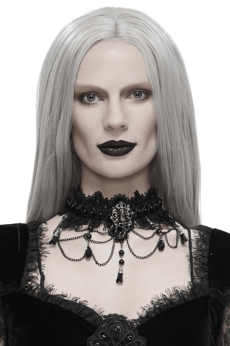 Elegant gothic model wearing a black lace necklace with rhinestones and a drop-shaped pendant, enhancing her dark look.
