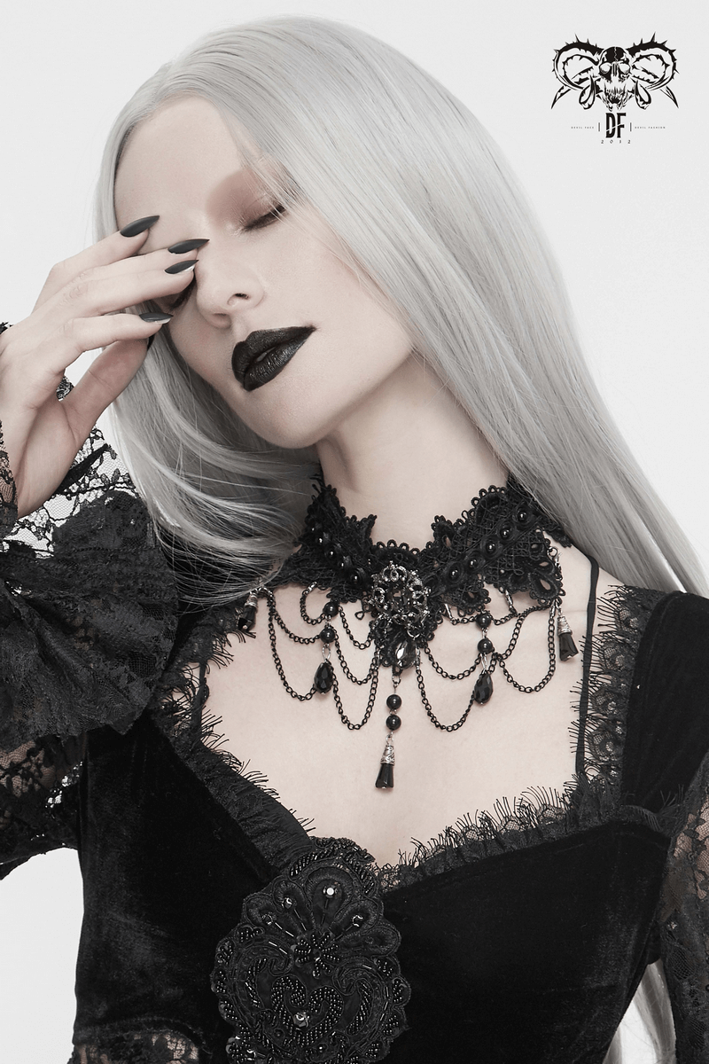 Elegant woman in gothic attire wearing a black lace necklace with rhinestones, showcasing a graceful and luxurious style.