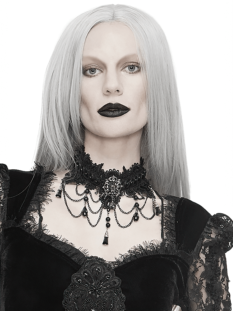 Elegant woman in gothic attire wearing a black lace necklace with rhinestones and a drop pendant, exuding graceful style.