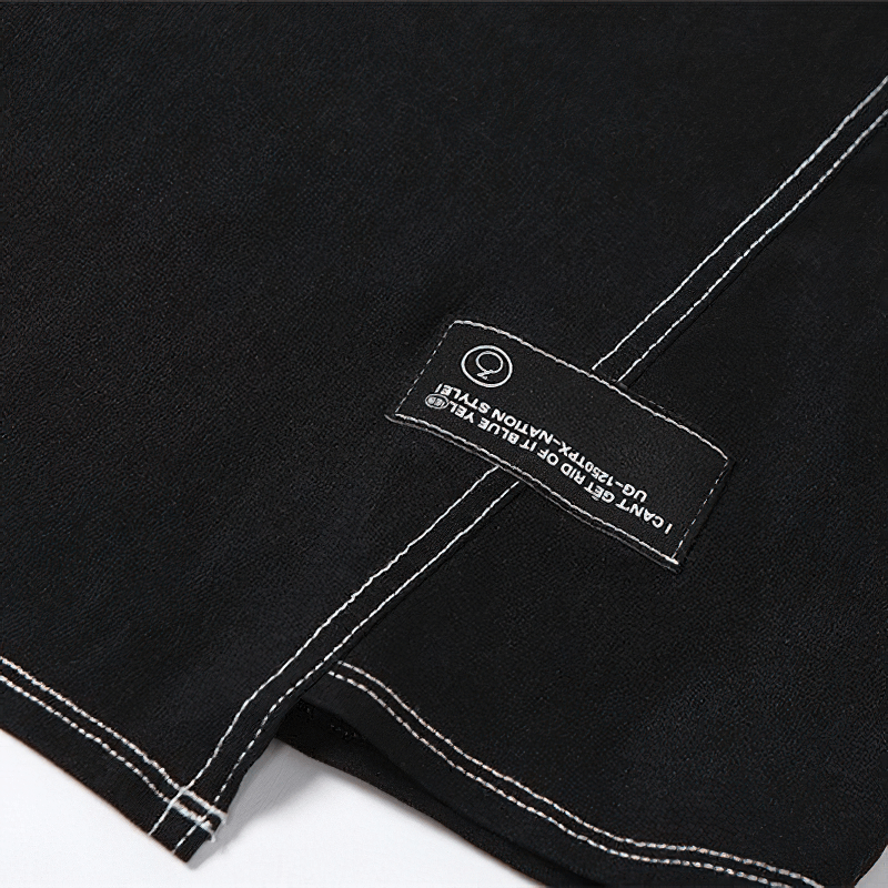 Close-up of a black fabric with a tag showing care instructions and stitching details.