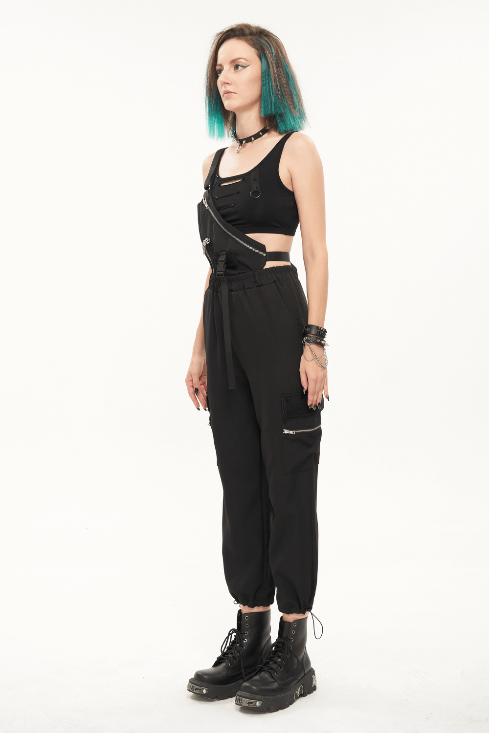 Model wearing women's punk asymmetrical suspender pants with skull rivets and stylish accessories.