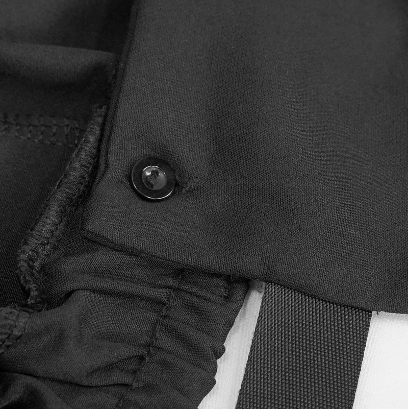 Close-up of the button detail on women's black drawstring suspender pants with punk style.