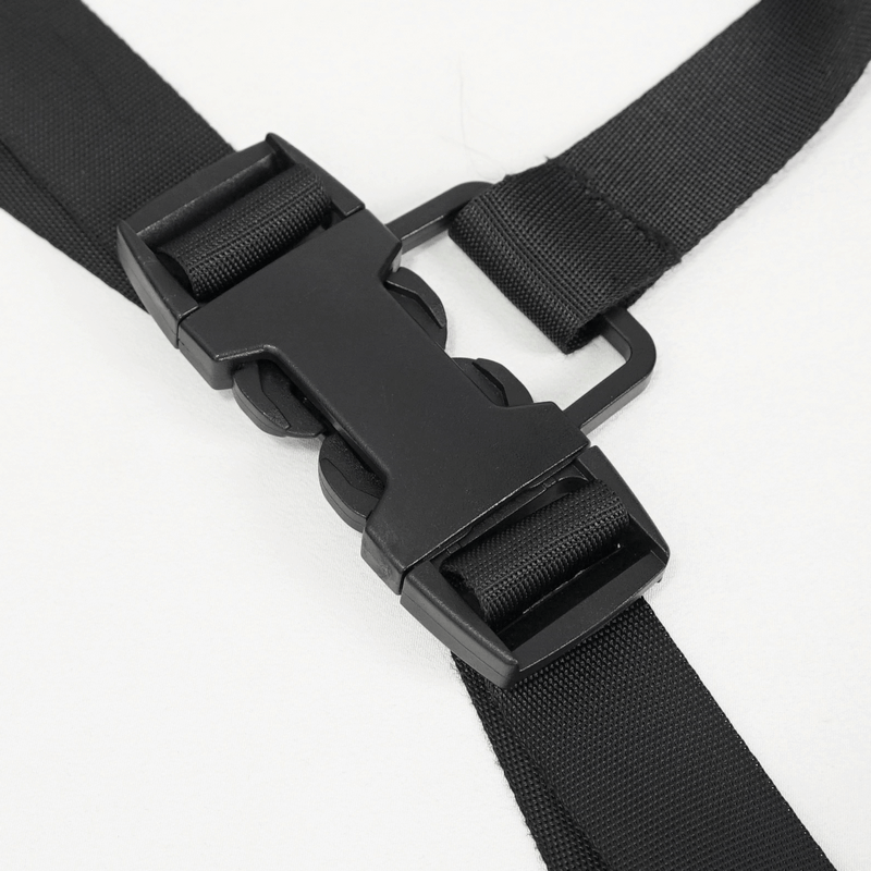 Close-up of a black buckle on a stylish suspender strap for women's punk asymmetrical pants.