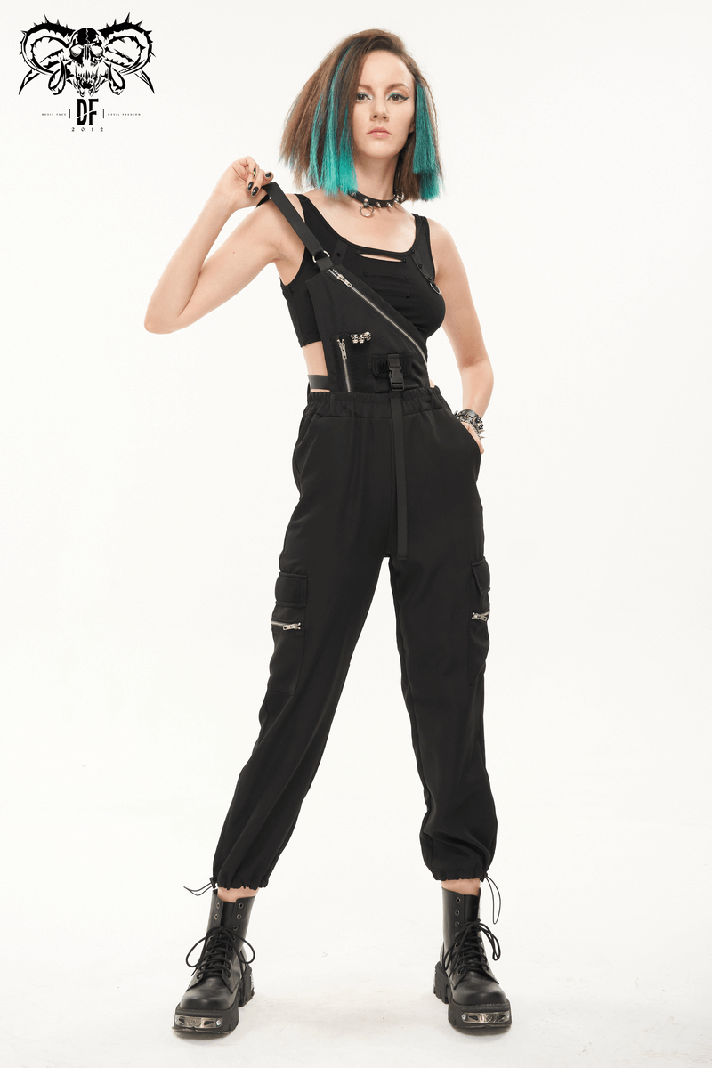 Punk style women's suspender pants with skull rivets, asymmetrical cut and zippers, worn by a model with blue hair.
