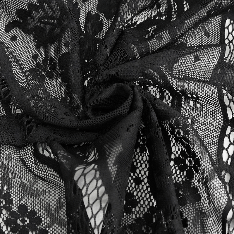 Close-up of intricate black lace fabric with floral patterns, perfect for gothic and vintage-inspired fashion.