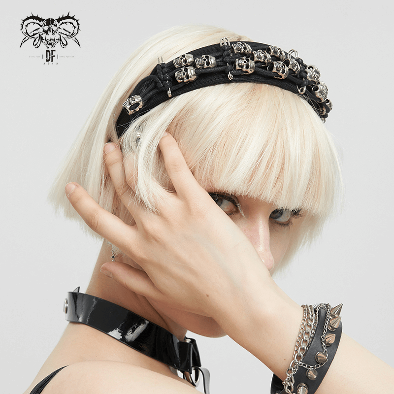 Stylish woman wearing a black skull hair band, showcasing gothic fashion and edgy accessories.