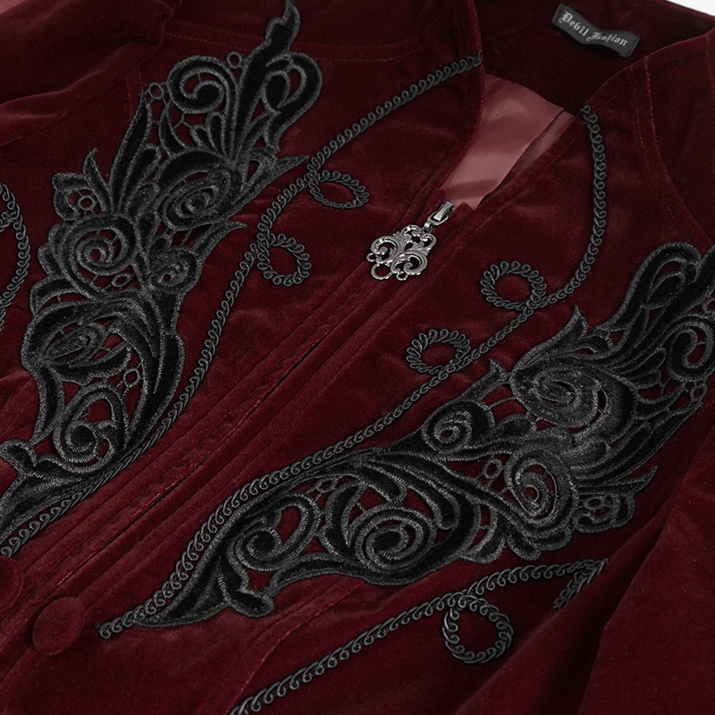 Close-up of women's wine red velvet jacket featuring black lace appliqué and decorative buttons.