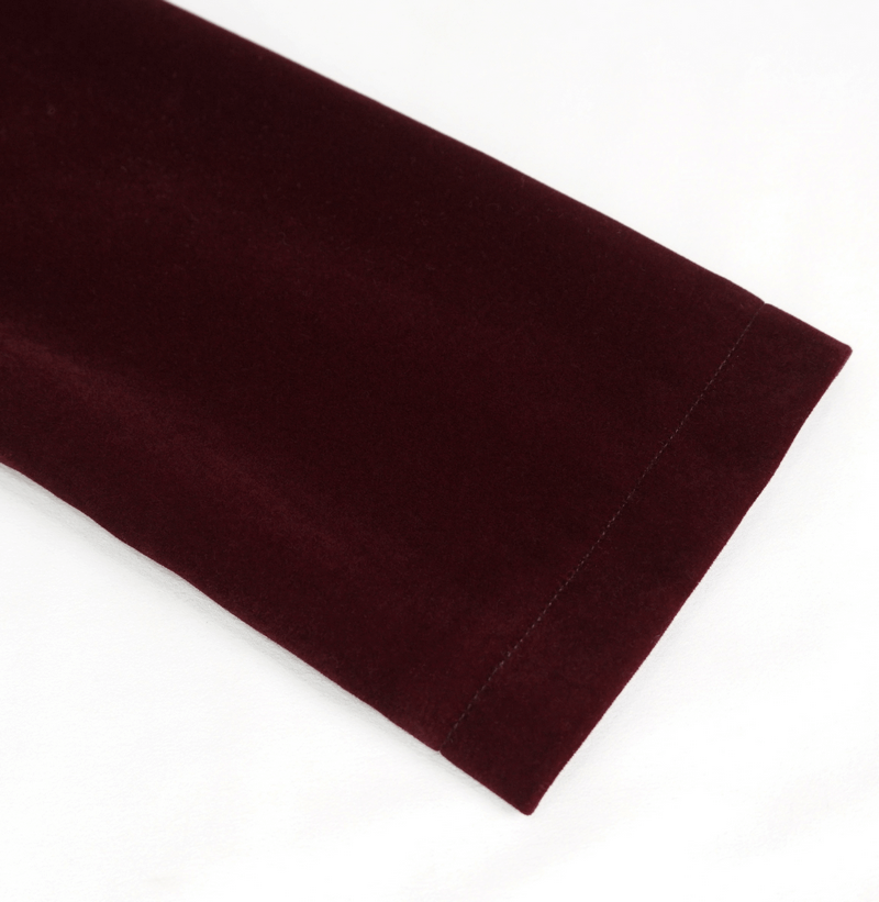 Close-up of the sleeve of a women's gothic wine red velvet jacket, showcasing its soft texture and elegant finish.