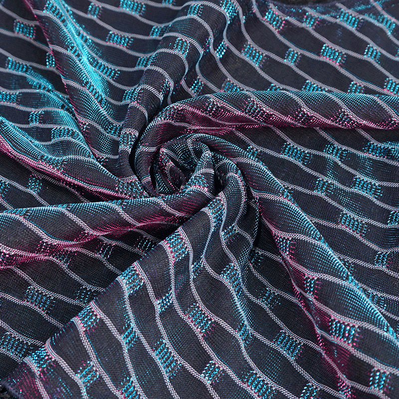 Close-up of grunge mesh fabric featuring vibrant turquoise and pink stripes, ideal for stylish tops.