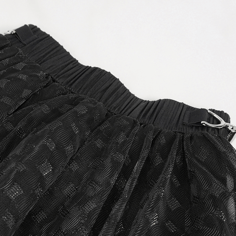 Close-up of the elastic waistband on a women's black layered mesh skirt in grunge style.