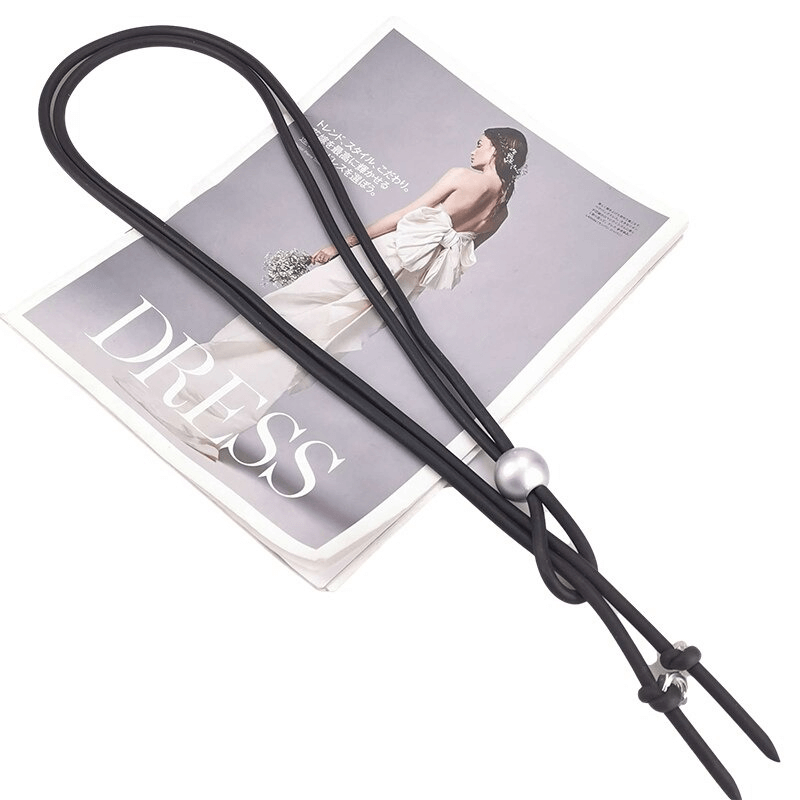 Punk style women's long necklace with pearl and screws, perfect accessory for edgy fashion, displayed on a magazine.