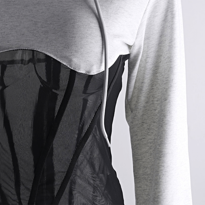Close-up of women's long sleeve hoodie featuring mesh see-through elements and zipper for a stylish casual look.