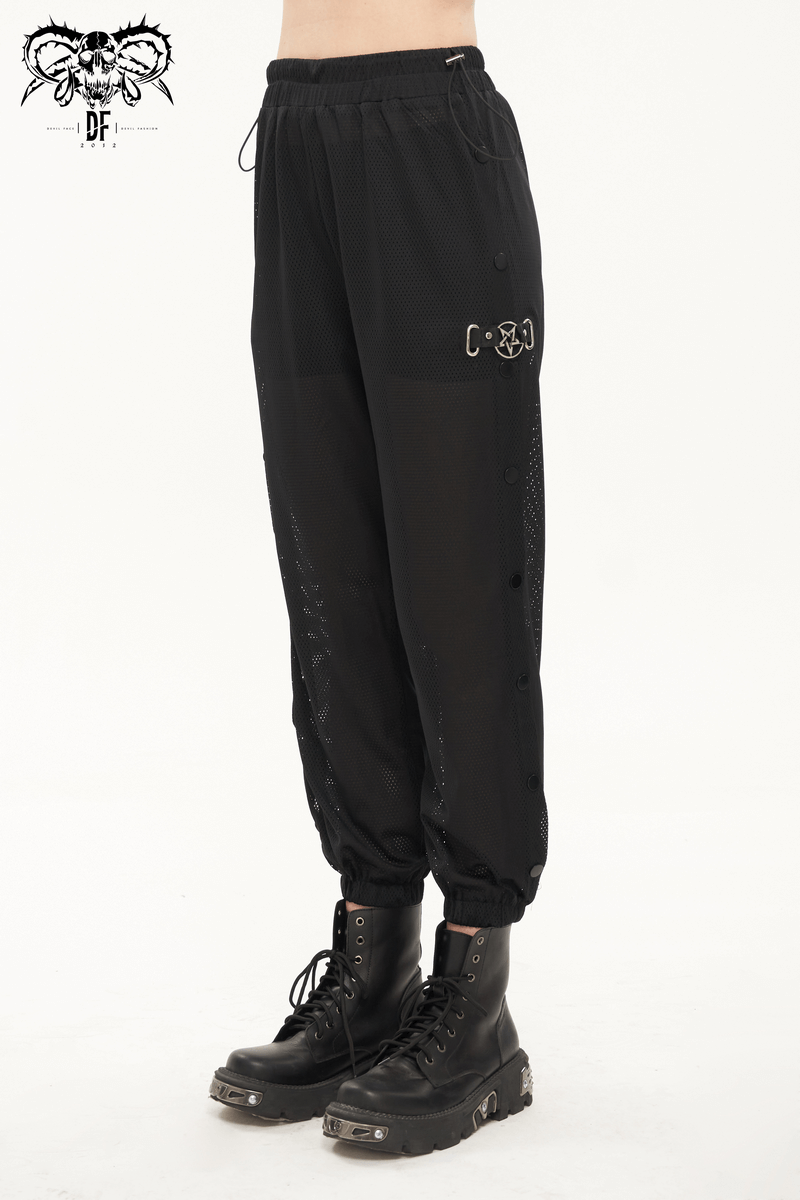 Women's black mesh buttoned jogger pants with punk style side openings and trendy cut, paired with stylish boots.