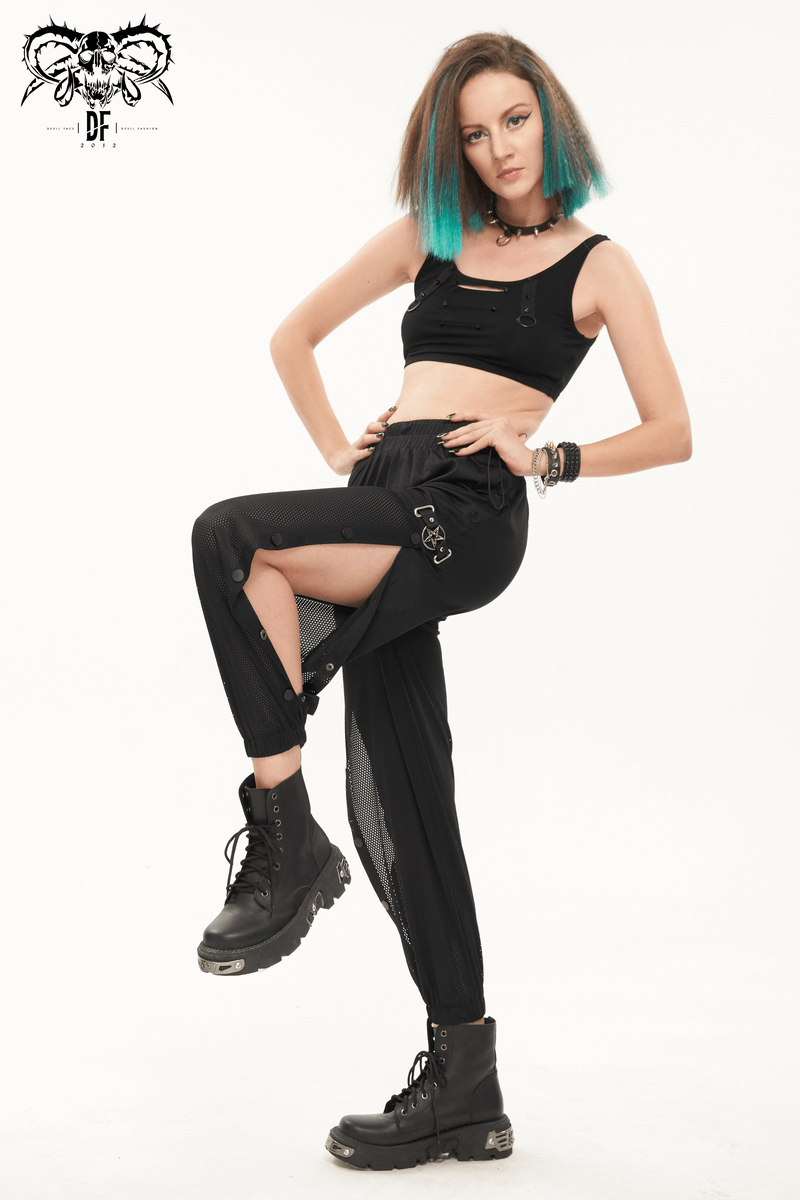 Trendy women's punk mesh jogger pants with side openings, paired with a stylish crop top and combat boots.