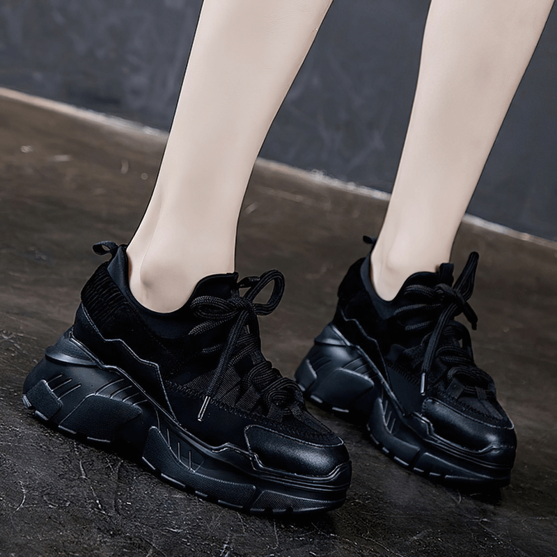 Stylish women's platform sneakers in black leather with lace-up design, perfect for casual wear.