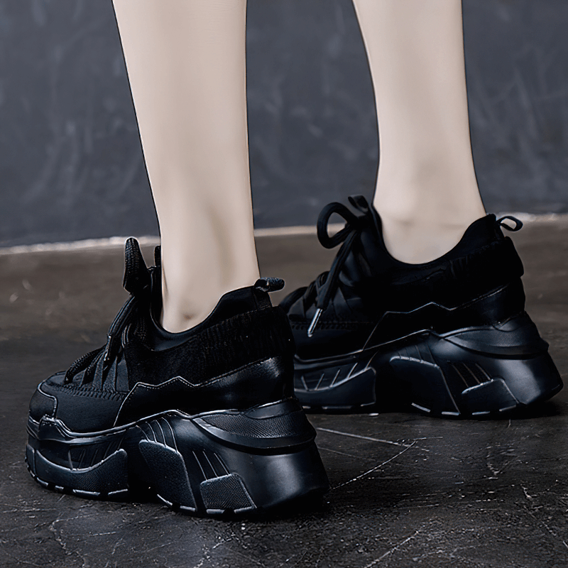 Stylish women's black platform sneakers with lace-up design and increased insole, perfect for casual outfits.