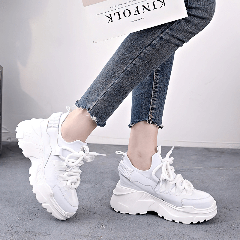 Stylish women's white platform sneakers with lace-up design, perfect for casual outfits and everyday wear.