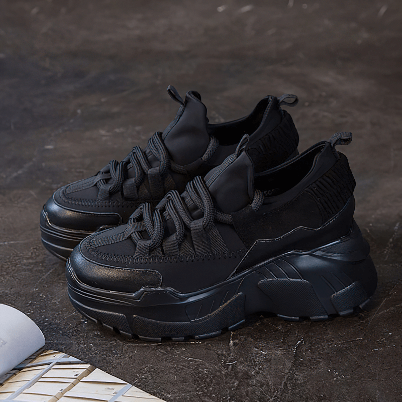 Stylish women's black platform sneakers made of genuine leather, perfect for casual wear and chic outfits.