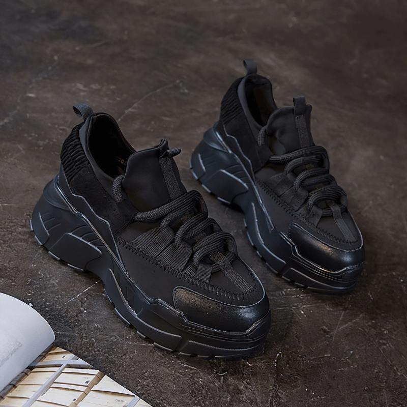 Women's stylish black platform sneakers with lace-up design, perfect for casual outings and superior comfort.