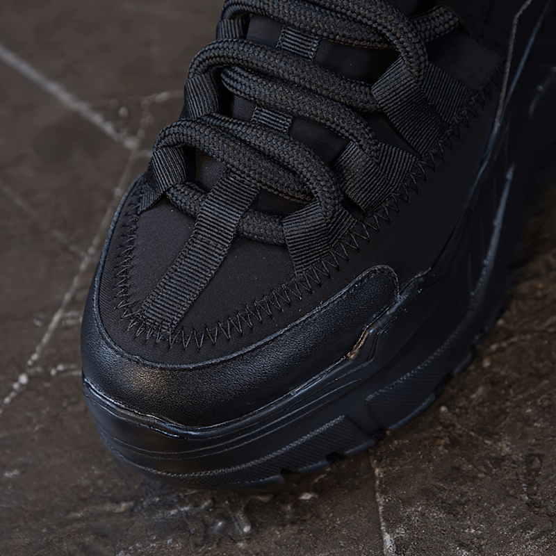 Close-up of women's platform genuine leather sneakers with stylish lace-up design and increased insole for casual wear.