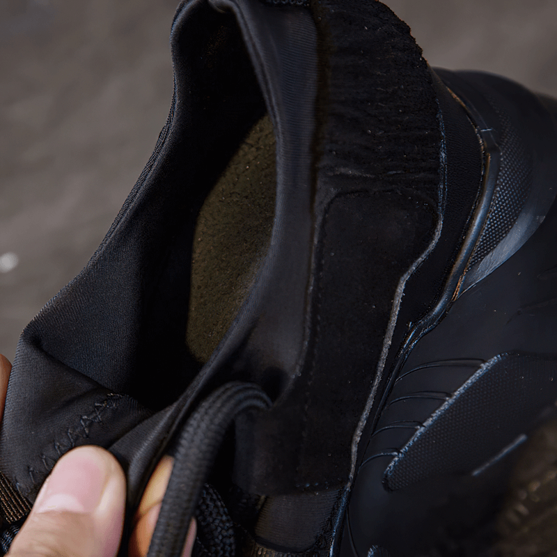 Close-up of the interior of a women's black platform leather sneaker showcasing its soft lining and lace design.