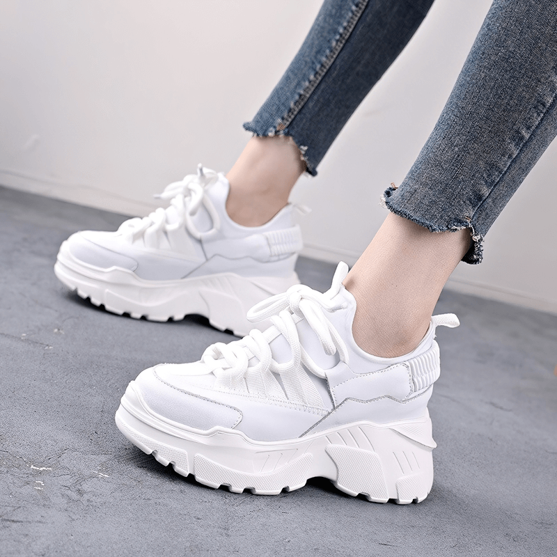 Stylish women's white platform sneakers with lace-up design, perfect for casual outfits and comfortable wear.