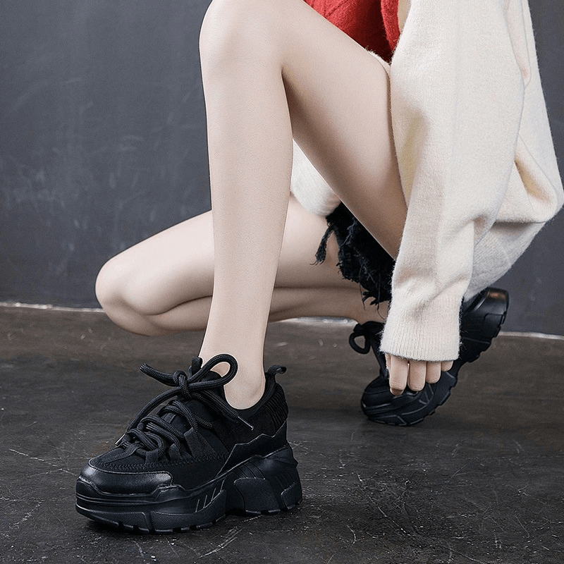 Stylish women's black platform genuine leather sneakers in casual outfit, perfect for everyday wear and trendy looks.