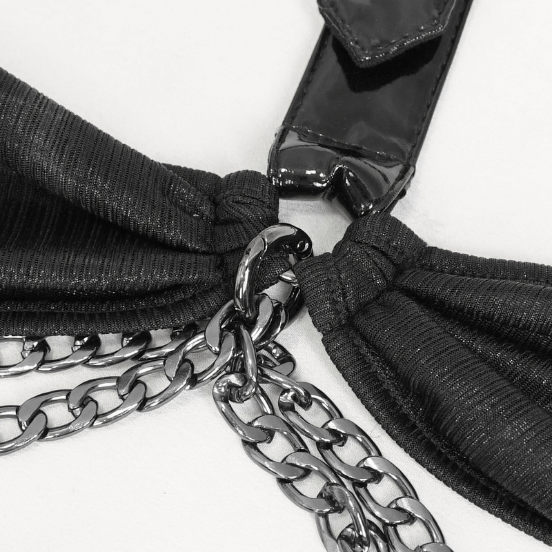 Close-up of women's gothic lingerie set with chains, showcasing stylish black fabric and metallic accents.