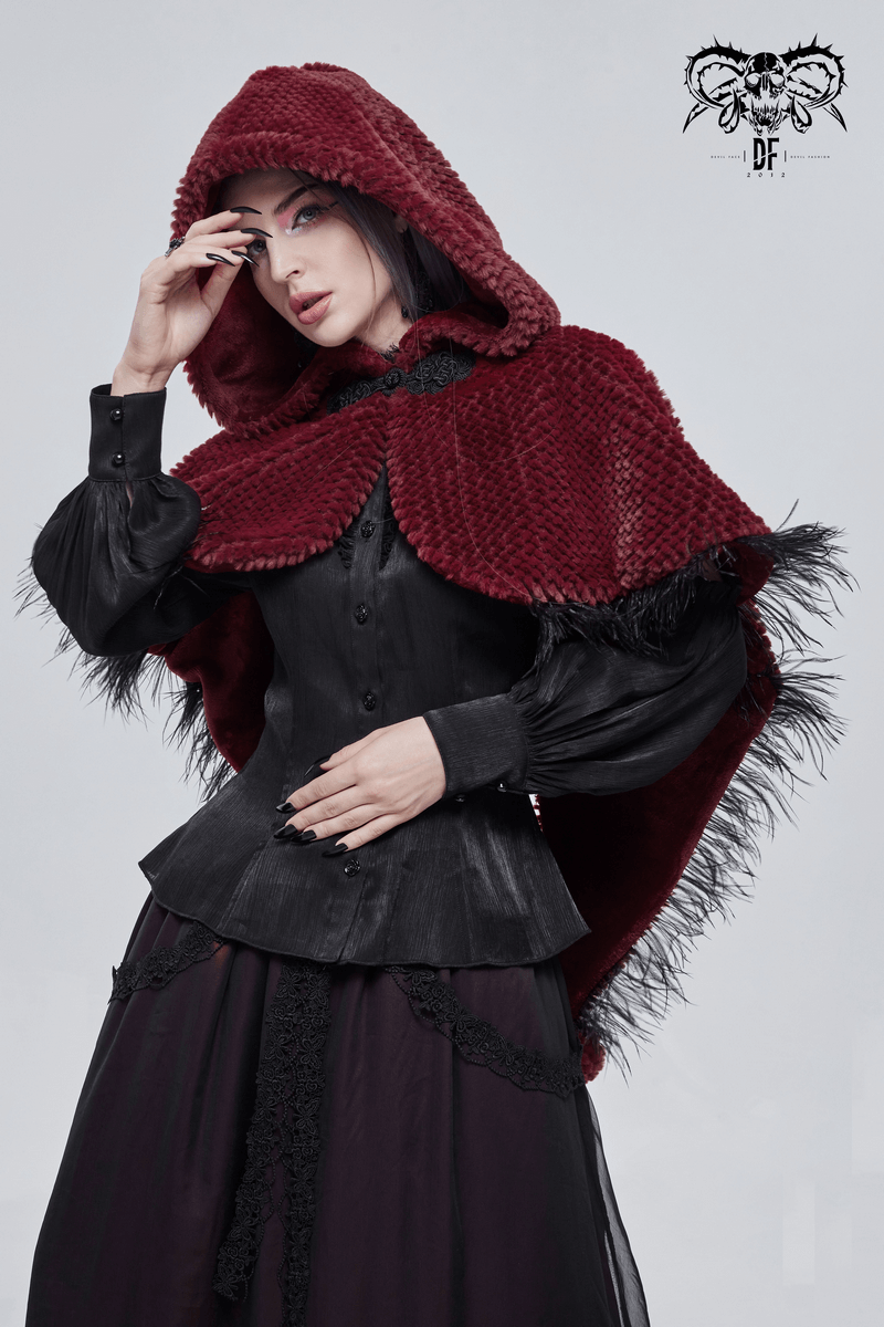Elegant woman wearing a red hooded short cape with fringes, showcasing gothic fashion style.