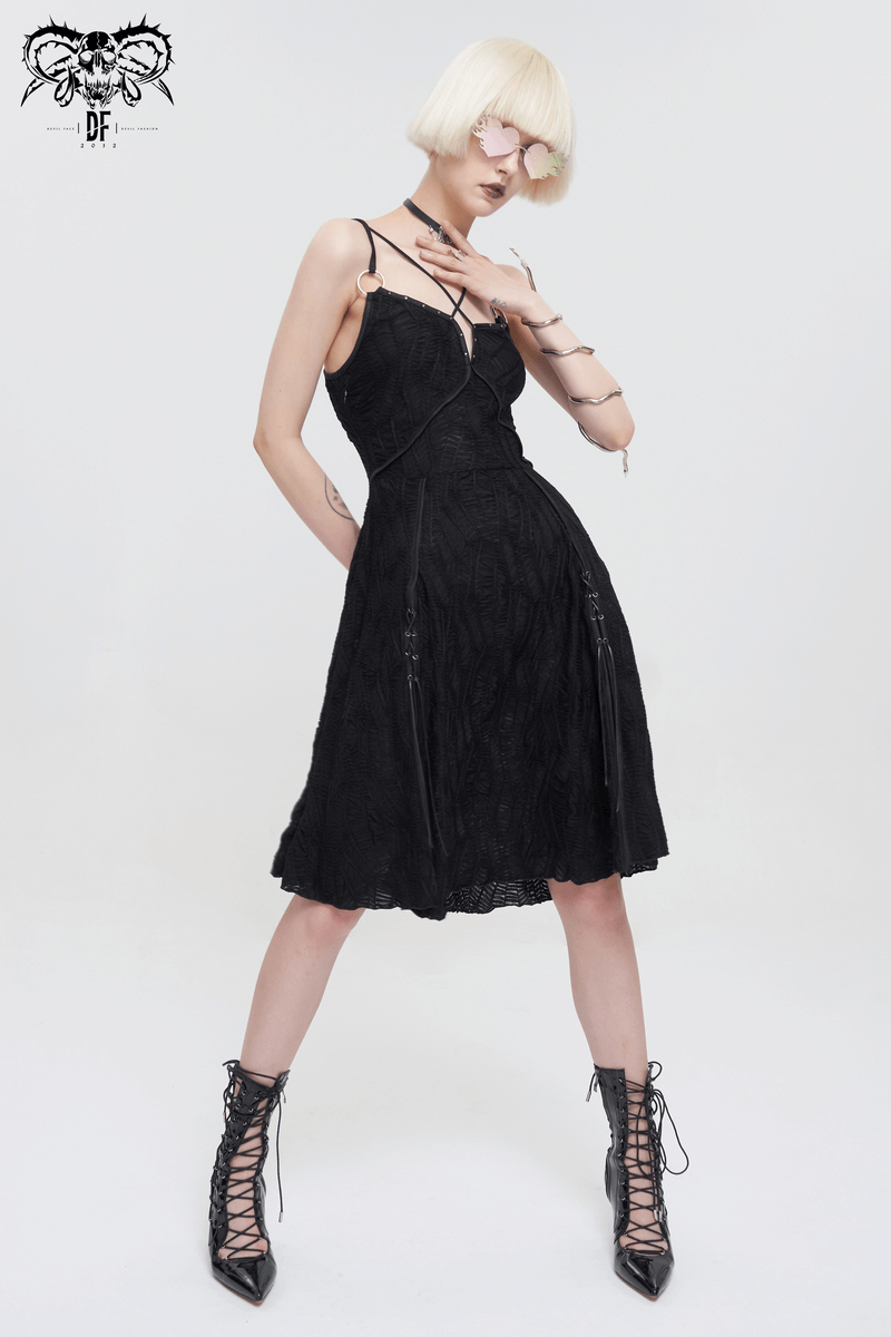 Woman in gothic punk black short dress with slit hem, showcasing modern fashion and edgy style.