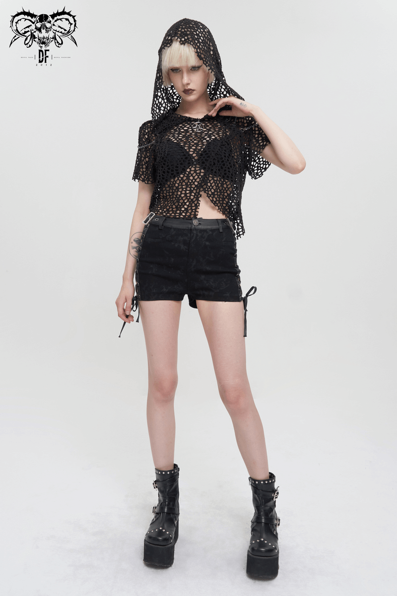 Women's short sleeve black mesh punk top with hood and strappy back, styled with black shorts and chunky boots.