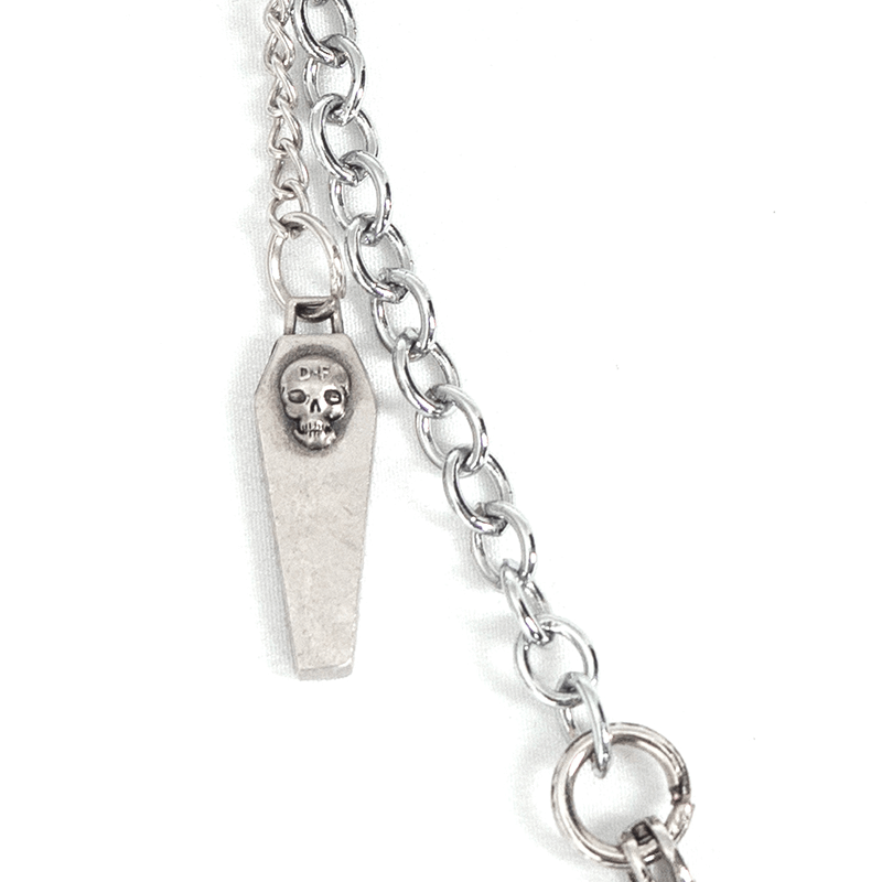 Gothic women's skull chain brooch featuring a coffin design and silver chain for an alternative look.
