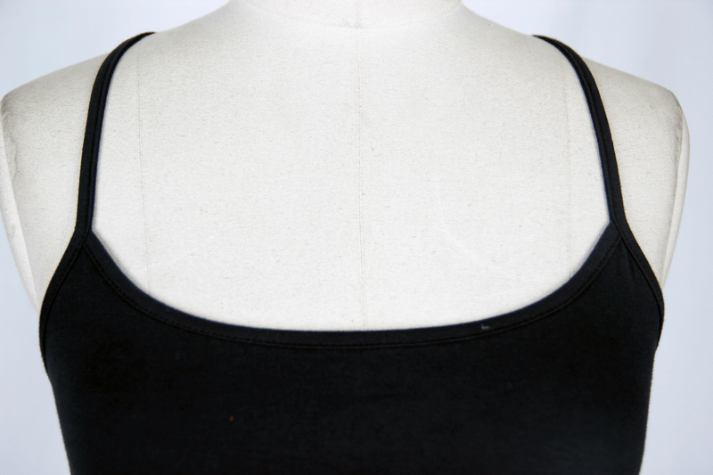 Close-up of a black asymmetrical camisole tank top showcasing the sleek neckline and thin straps.