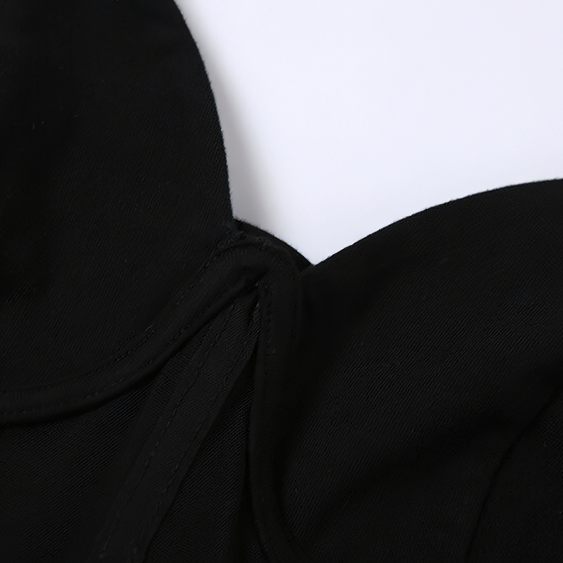 Close-up of the neckline and fabric of a women's black A-line short dress, showcasing its elegant and casual style.