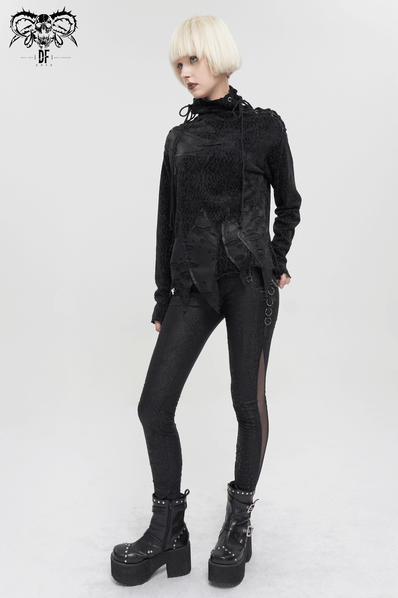 Stylish woman in a black gothic turtleneck ripped sweatshirt paired with edgy leggings and platform boots.